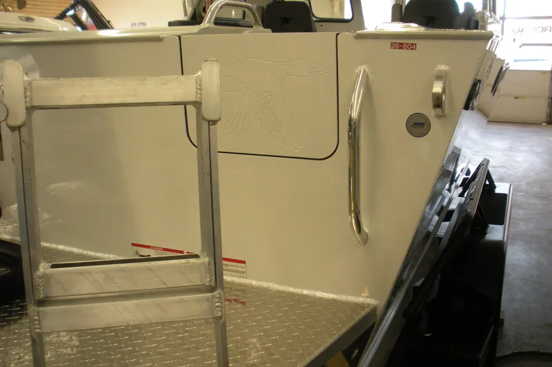 Slide: The Image of 2026 Duckworth 21 Discovery boat with ladder and engraved bird design. - 22