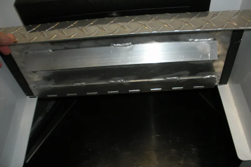 Slide: The Image of Interior view of a 2026 Duckworth 21 Discovery boat with metal detailing. - 6