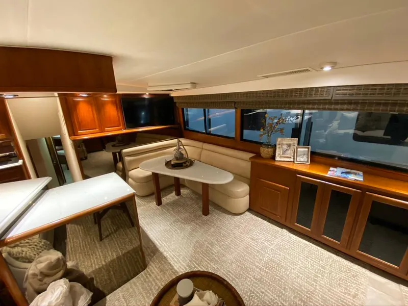 Slide: The Image of Luxurious interior of a 1990 Viking 53 Convertible yacht with elegant seating and wood finishes. - 12