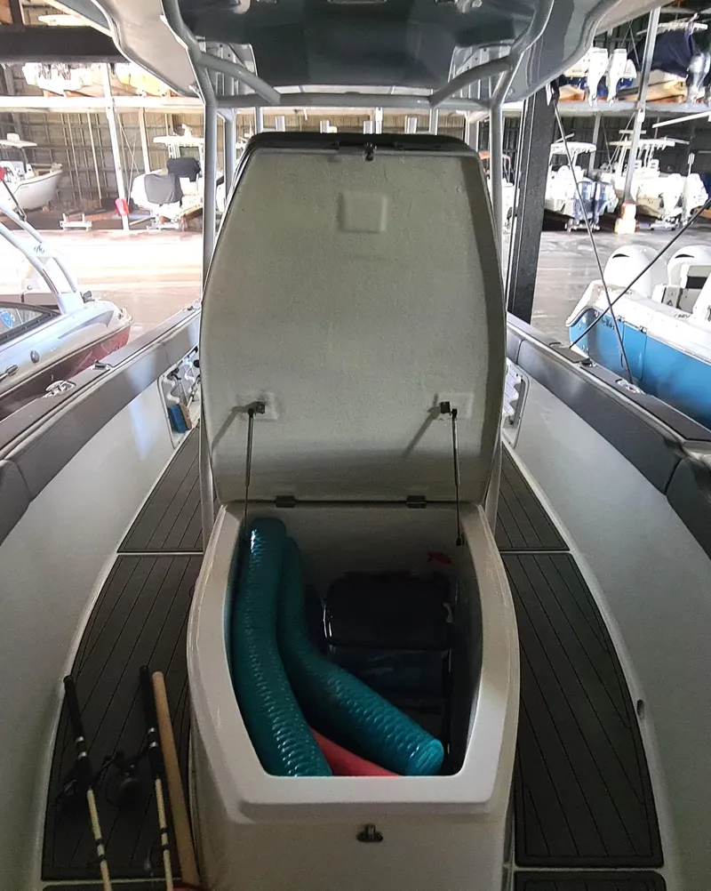 Slide: The Image of Open storage compartment on 2021 Clearwater 2800 CC boat, showing interior space and equipment. - 10