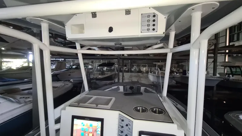 Slide: The Image of 2021 Clearwater 2800 CC boat interior with control panel and navigation screens. - 17