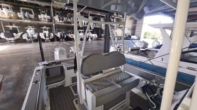 Slide: The Image of 2021 Clearwater 2800 CC boat interior in storage facility with multiple boats. - 18