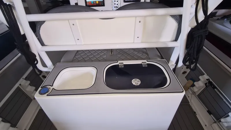 Slide: The Image of 2021 Clearwater 2800 CC boat interior with dual sinks and storage area. - 21