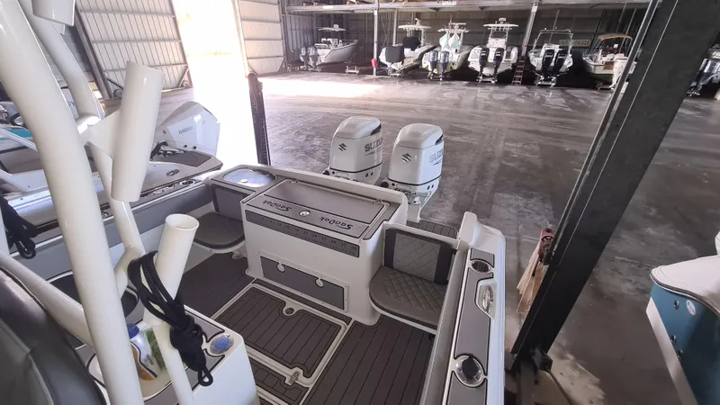 Slide: The Image of 2021 Clearwater 2800 CC boat interior with dual engines in a storage facility. - 22
