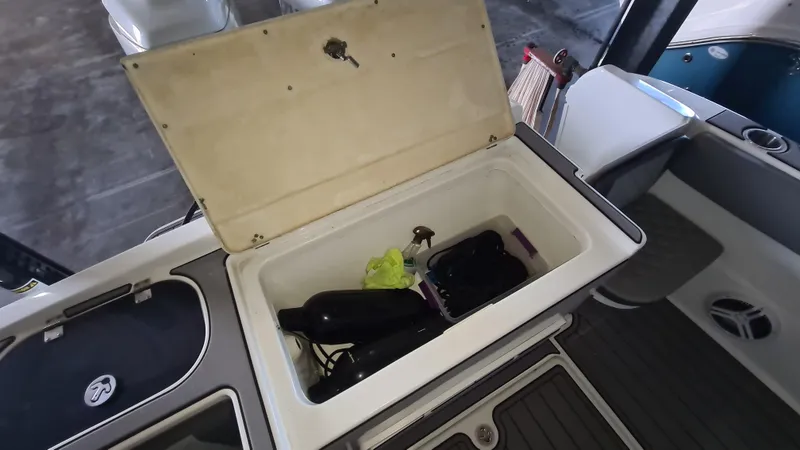 Slide: The Image of Open storage compartment on 2021 Clearwater 2800 CC boat with items inside. - 23