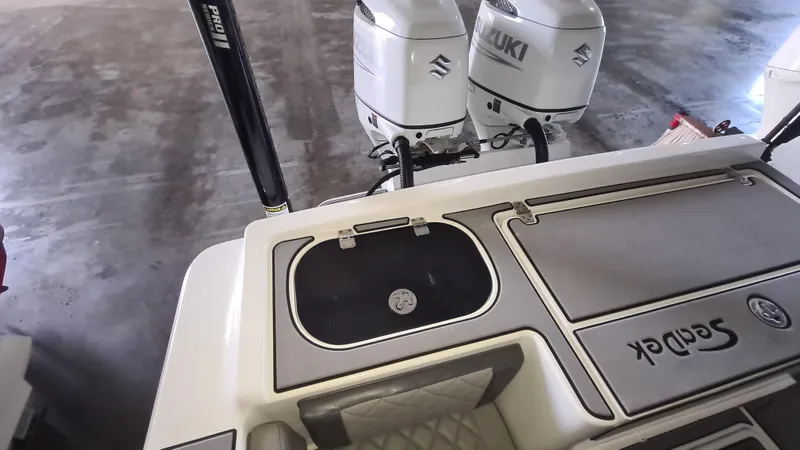 Slide: The Image of 2021 Clearwater 2800 CC boat with dual Suzuki outboard motors and SeaDek flooring. - 24