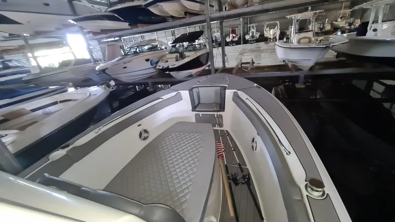 Slide: The Image of 2021 Clearwater 2800 CC boat in indoor storage with other vessels. - 6