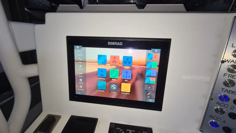 Slide: The Image of Simrad display on 2021 Clearwater 2800 CC boat dashboard with navigation controls. - 12
