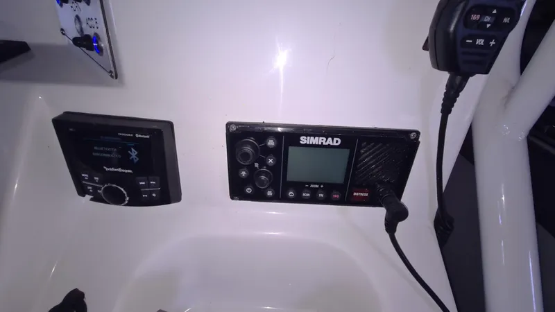 Slide: The Image of Control panel of a 2021 Clearwater 2800 CC boat with Simrad electronics. - 14