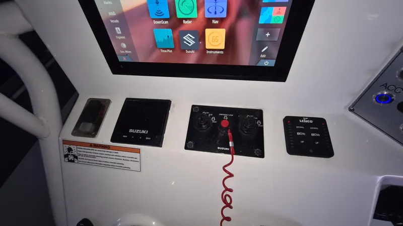 Slide: The Image of Control panel of a 2021 Clearwater 2800 CC boat with touchscreen and switches. - 16