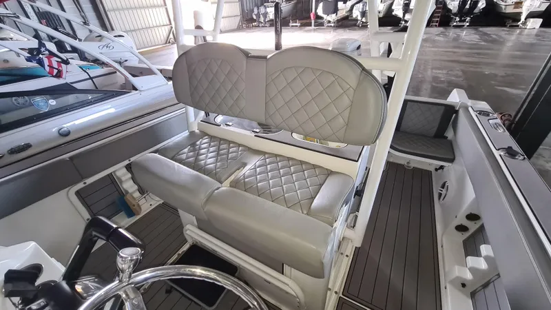 Slide: The Image of 2021 Clearwater 2800 CC boat interior with quilted seating and steering wheel. - 19