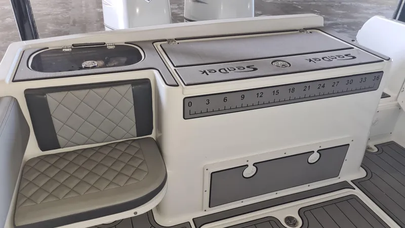 Slide: The Image of 2021 Clearwater 2800 CC boat interior with seating and storage compartments. - 26