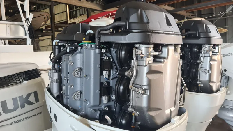 Slide: The Image of Outboard engines on a 2021 Clearwater 2800 CC boat in a workshop setting. - 30