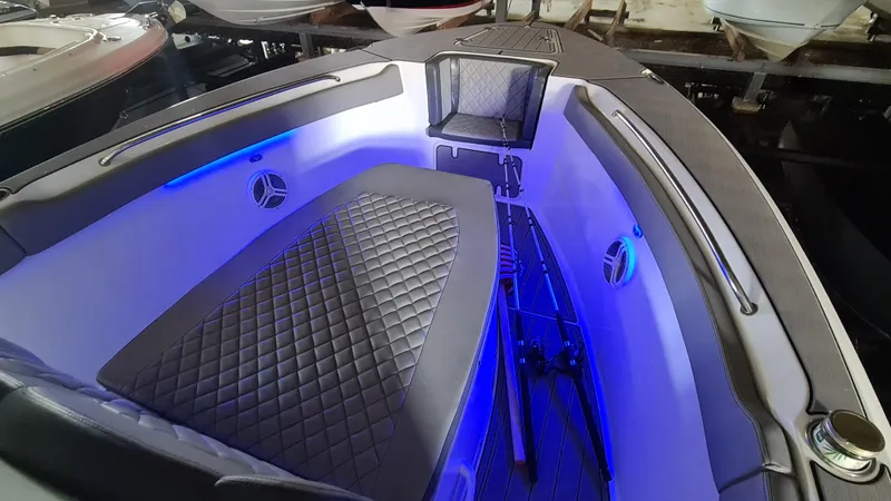 Slide: The Image of 2021 Clearwater 2800 CC boat interior with blue LED lighting and quilted seating. - 7