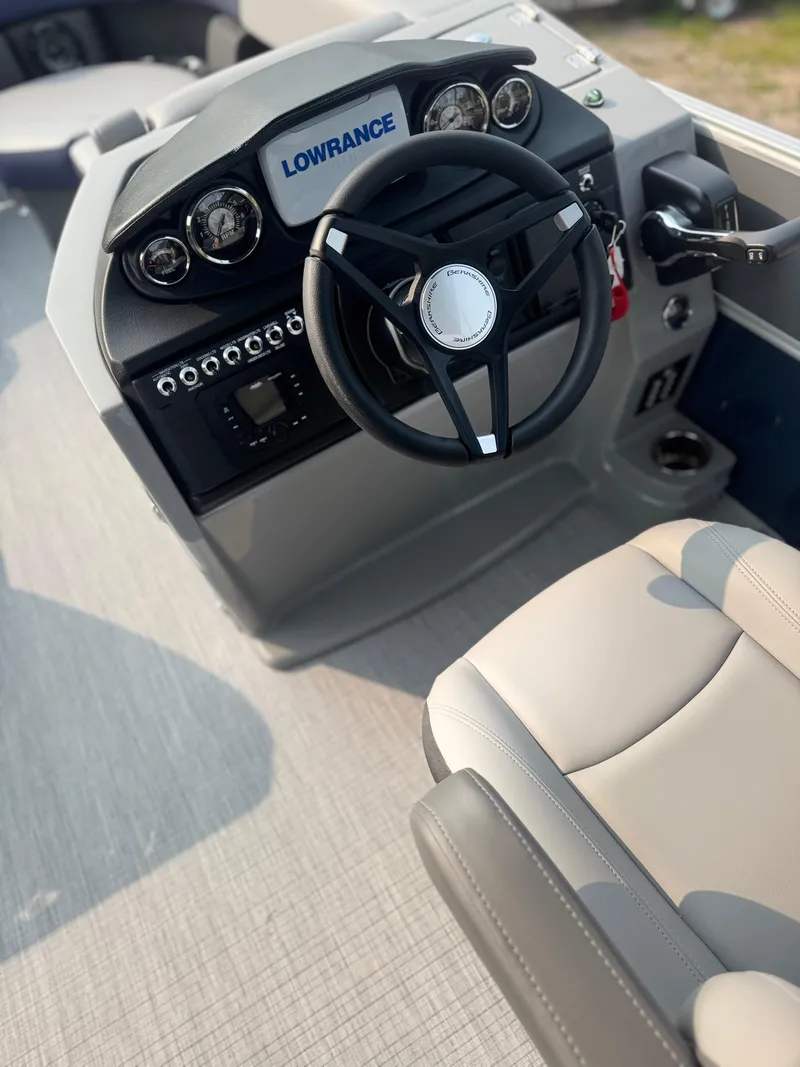 Slide: The Image of 2025 Berkshire 22CL CTS boat dashboard with steering wheel and Lowrance display. - 11