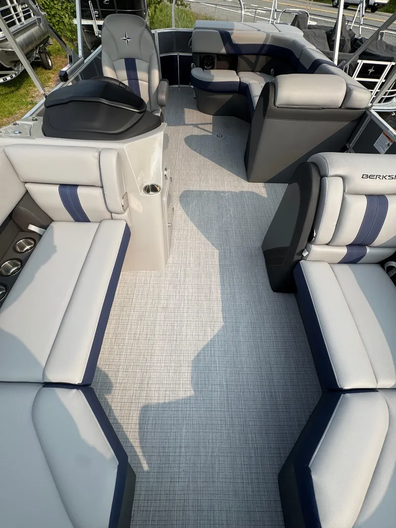 Slide: The Image of 2025 Berkshire 22CL CTS pontoon boat interior with plush seating and modern design. - 5