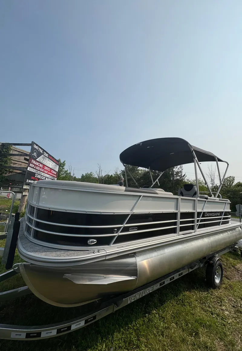 Slide: The Image of 2025 Berkshire 22RFX LE pontoon boat with canopy on trailer. - 2