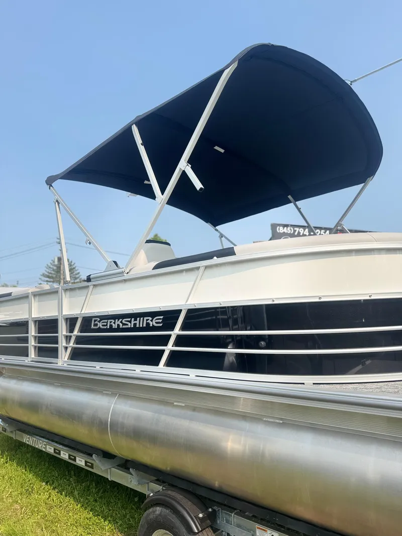 Slide: The Image of 2025 Berkshire 22RFX LE pontoon boat with canopy, side view. - 3
