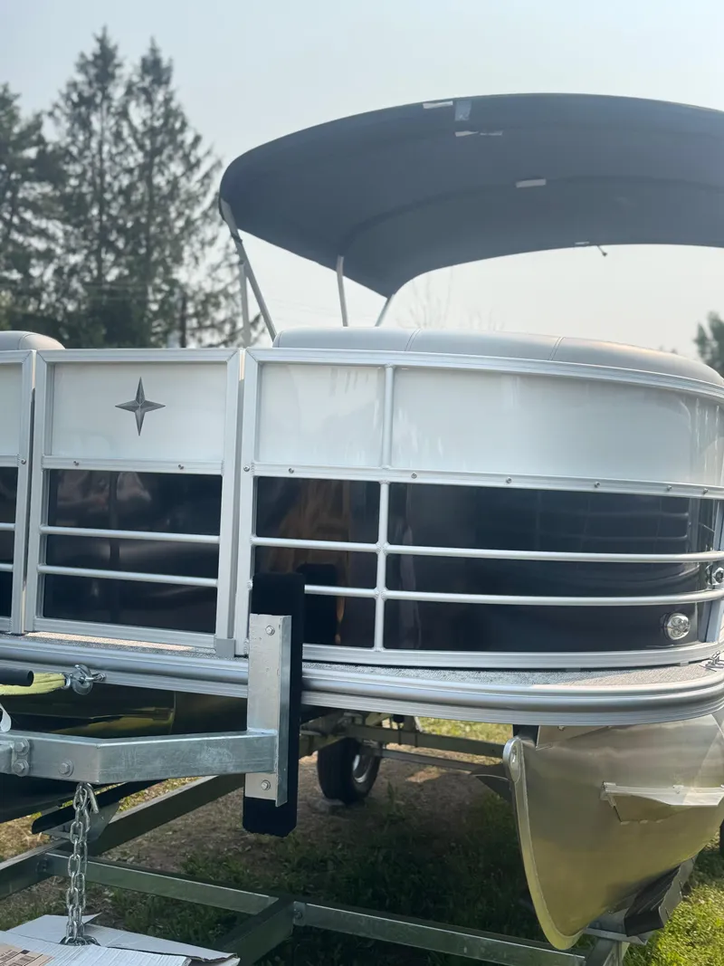 Slide: The Image of 2025 Berkshire 22RFX LE pontoon boat with canopy, parked on a trailer. - 5