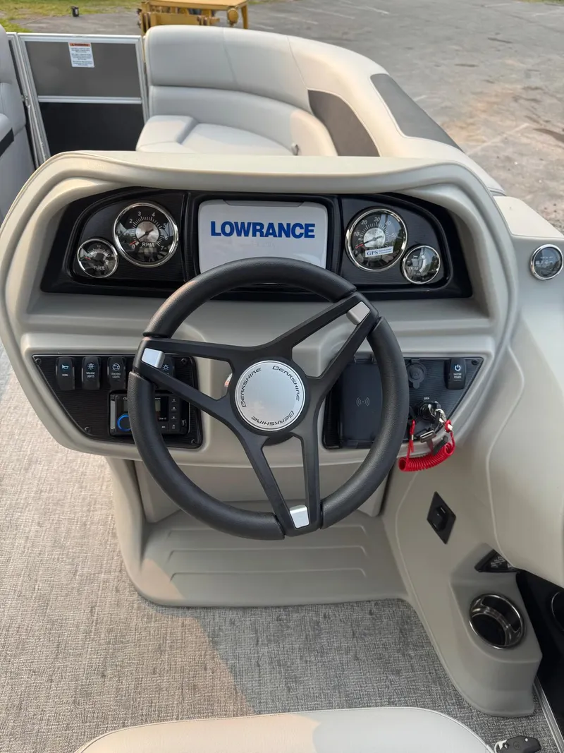 Slide: The Image of 2025 Berkshire 22RFX LE boat dashboard with steering wheel and Lowrance display. - 6