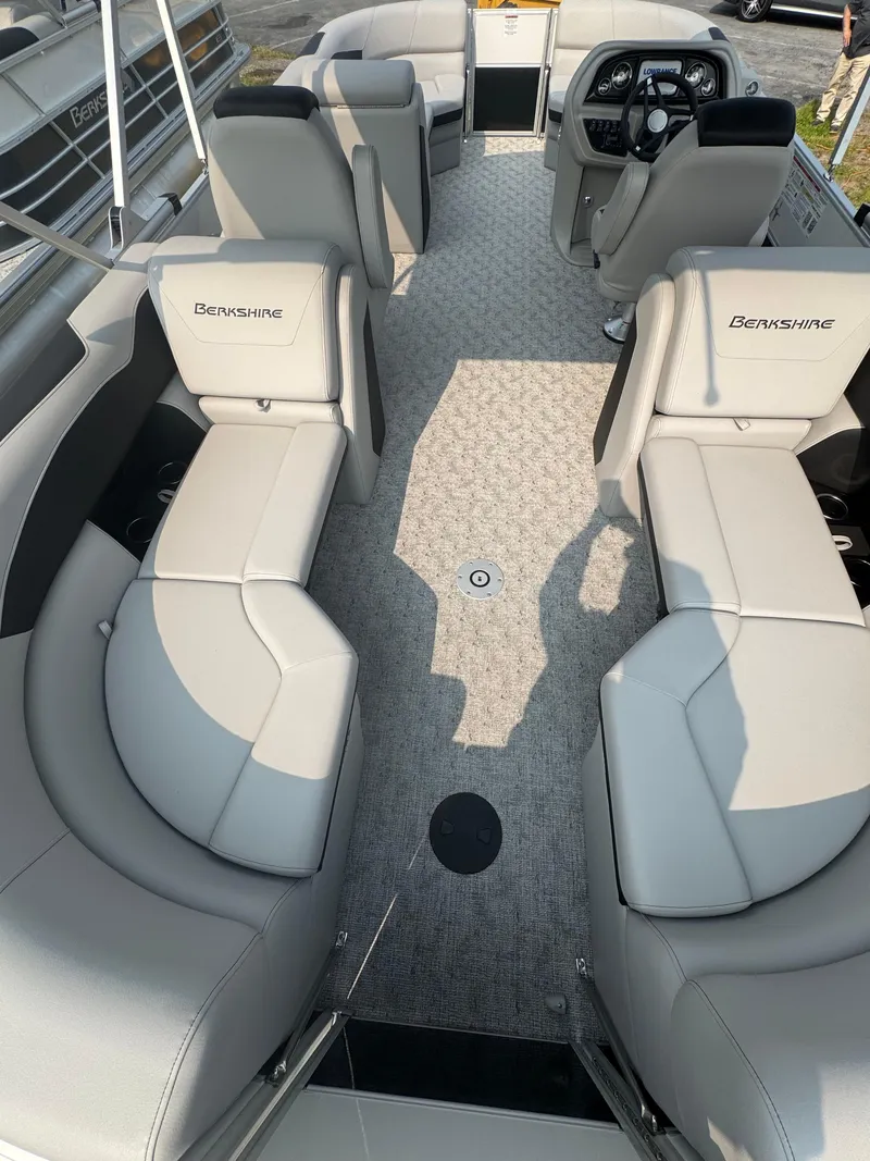 Slide: The Image of 2025 Berkshire 22RFX LE pontoon boat interior with plush seating and modern dashboard. - 8