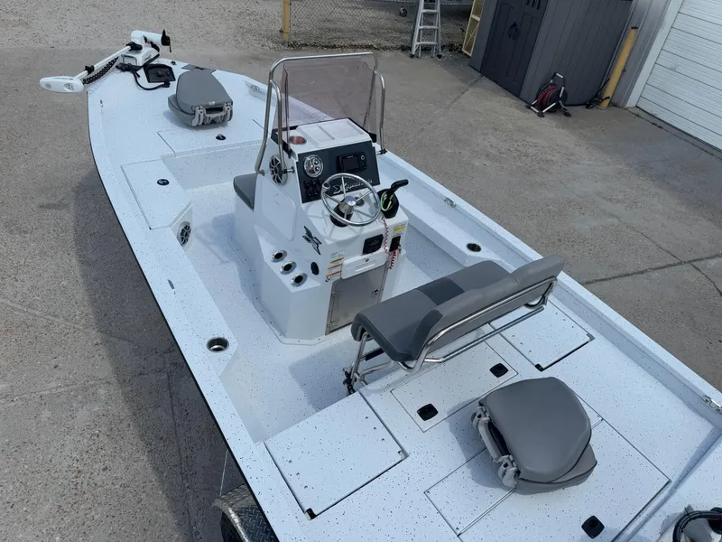 Slide: The Image of 2022 Xpress H20B boat with center console and seating, parked on concrete. - 10