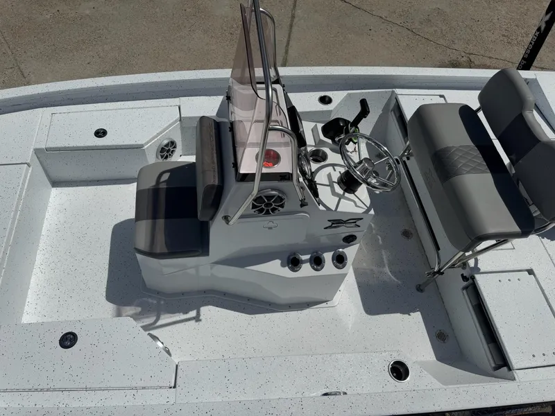 Slide: The Image of 2022 Xpress H20B boat interior with steering console and seating, featuring a sleek design. - 13