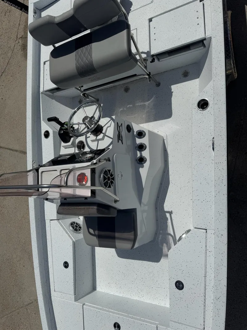 Slide: The Image of 2022 Xpress H20B boat interior with steering console and seating, top view. - 15