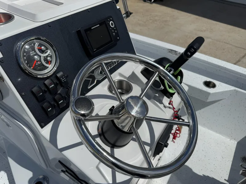 Slide: The Image of Steering console of 2022 Xpress H20B boat with gauges and controls. - 20
