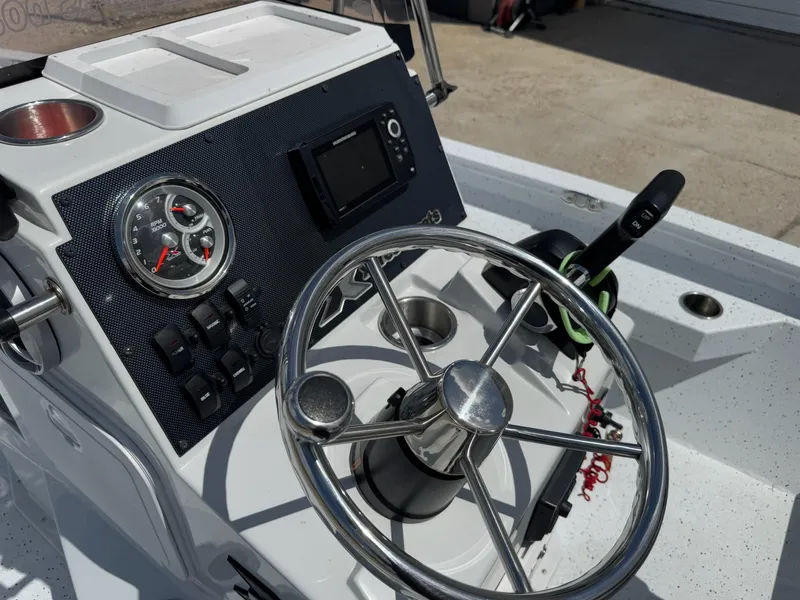 Slide: The Image of 2022 Xpress H20B boat console with steering wheel, gauges, and controls. - 21