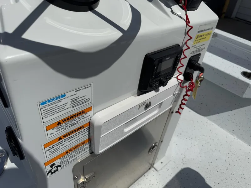 Slide: The Image of Control panel of 2022 Xpress H20B boat with safety warnings and ignition keys. - 22