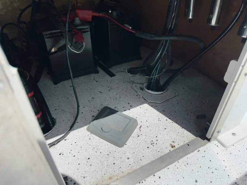 Slide: The Image of Interior of 2022 Xpress H20B boat showing battery compartment and wiring. - 23