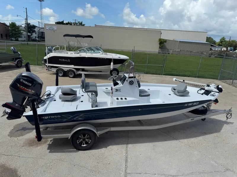Slide: The Image of 2022 Xpress H20B boat with Yamaha engine on trailer, parked outdoors. - 3
