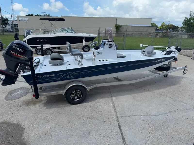 Slide: The Image of 2022 Xpress H20B boat with Yamaha engine on trailer, parked outdoors. - 4