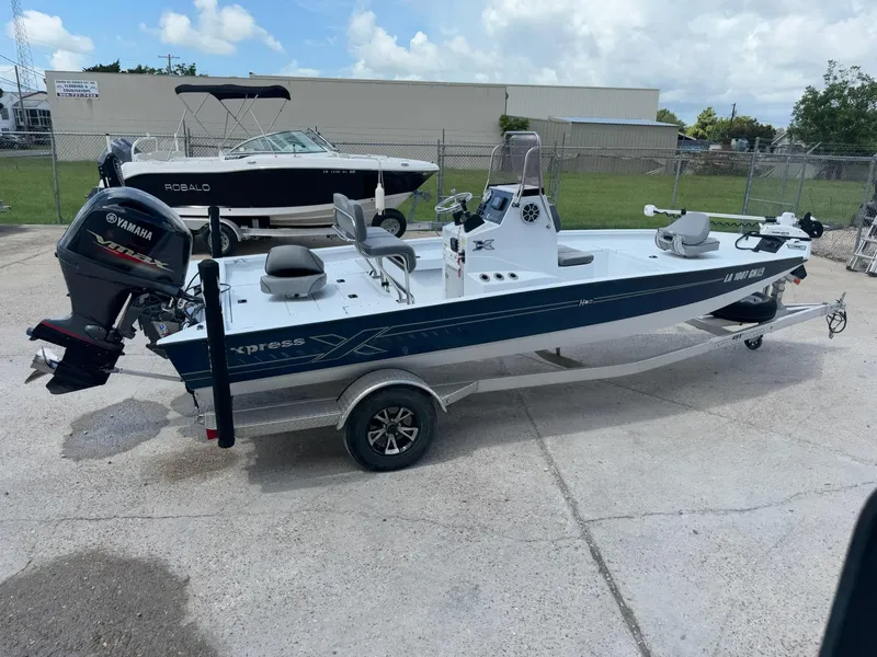 Slide: The Image of 2022 Xpress H20B boat with Yamaha engine on trailer, parked outdoors. - 5