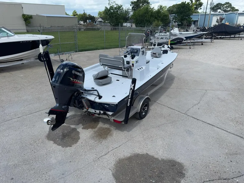 Slide: The Image of 2022 Xpress H20B boat with Yamaha engine, parked outdoors on concrete. - 6