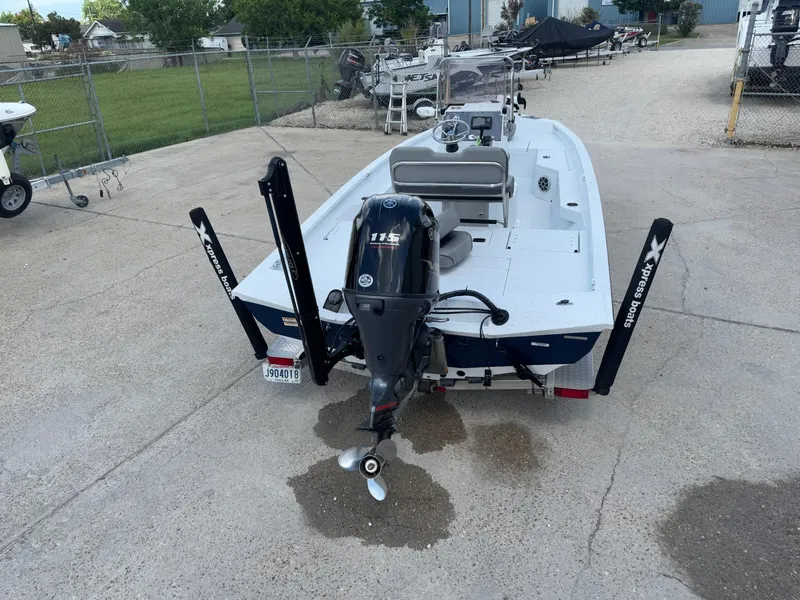 Slide: The Image of 2022 Xpress H20B boat with Yamaha 115 engine, parked on concrete. - 7