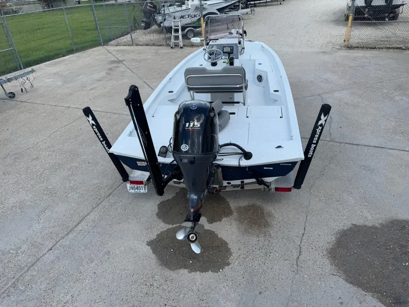 Slide: The Image of 2022 Xpress H20B boat with Yamaha 115 engine, parked on concrete. - 8