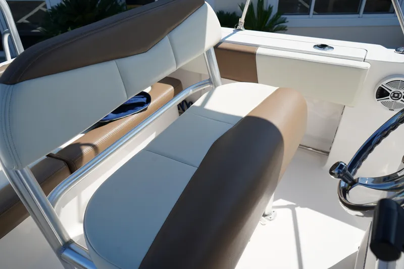 Slide: The Image of 2017 Robalo R200ES boat interior with brown and white seating. - 12