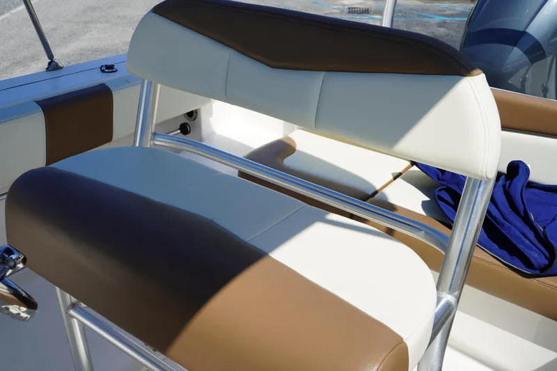 Slide: The Image of 2017 Robalo R200ES boat interior with brown and white seating. - 13