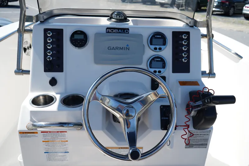 Slide: The Image of 2017 Robalo R200ES boat dashboard with Garmin navigation system and steering wheel. - 14