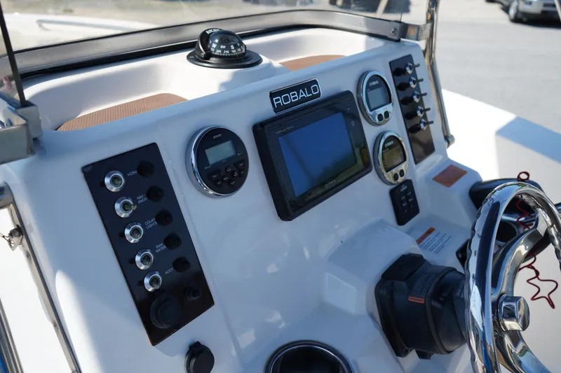 Slide: The Image of 2017 Robalo R200ES boat dashboard with navigation controls and instruments. - 16