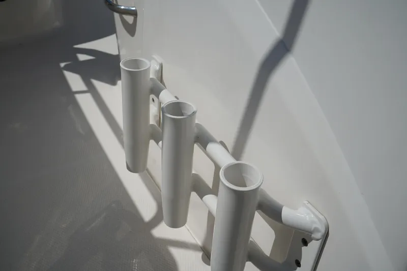 Slide: The Image of Rod holders on 2017 Robalo R200ES boat, mounted on white interior surface. - 18