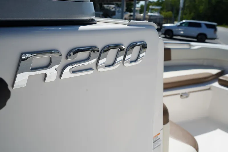 Slide: The Image of 2017 Robalo R200ES boat with chrome logo, white and beige interior. - 20