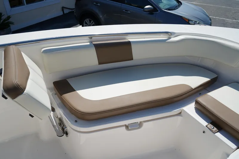 Slide: The Image of 2017 Robalo R200ES boat interior with cushioned seating and sleek design. - 24