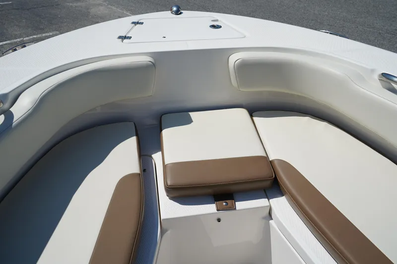 Slide: The Image of 2017 Robalo R200ES boat interior with cushioned seating in white and brown. - 26