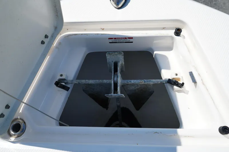 Slide: The Image of 2017 Robalo R200ES anchor compartment with open hatch, showcasing anchor storage. - 30