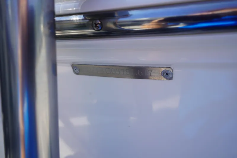 Slide: The Image of 2017 Robalo R200ES boat identification plate with metal screws. - 32