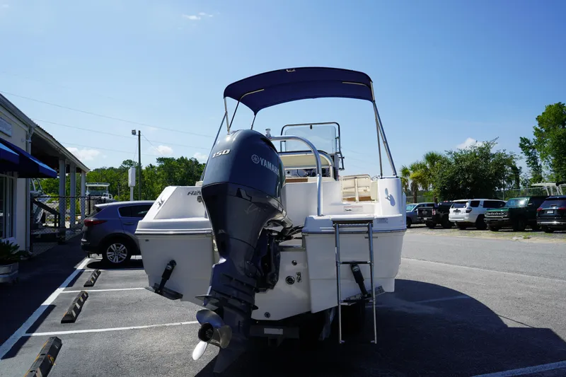 Slide: The Image of 2017 Robalo R200ES boat with Yamaha engine, parked outdoors under clear blue sky. - 4