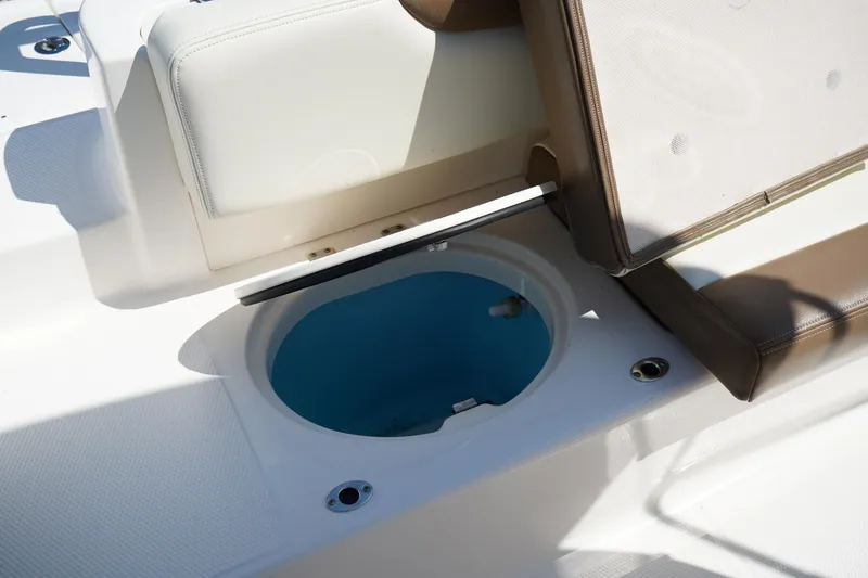 Slide: The Image of 2017 Robalo R200ES boat with open storage compartment, white and brown seating. - 9
